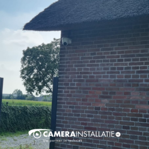Rietgedekte woning met een camera hoog op de gemetselde topgevel