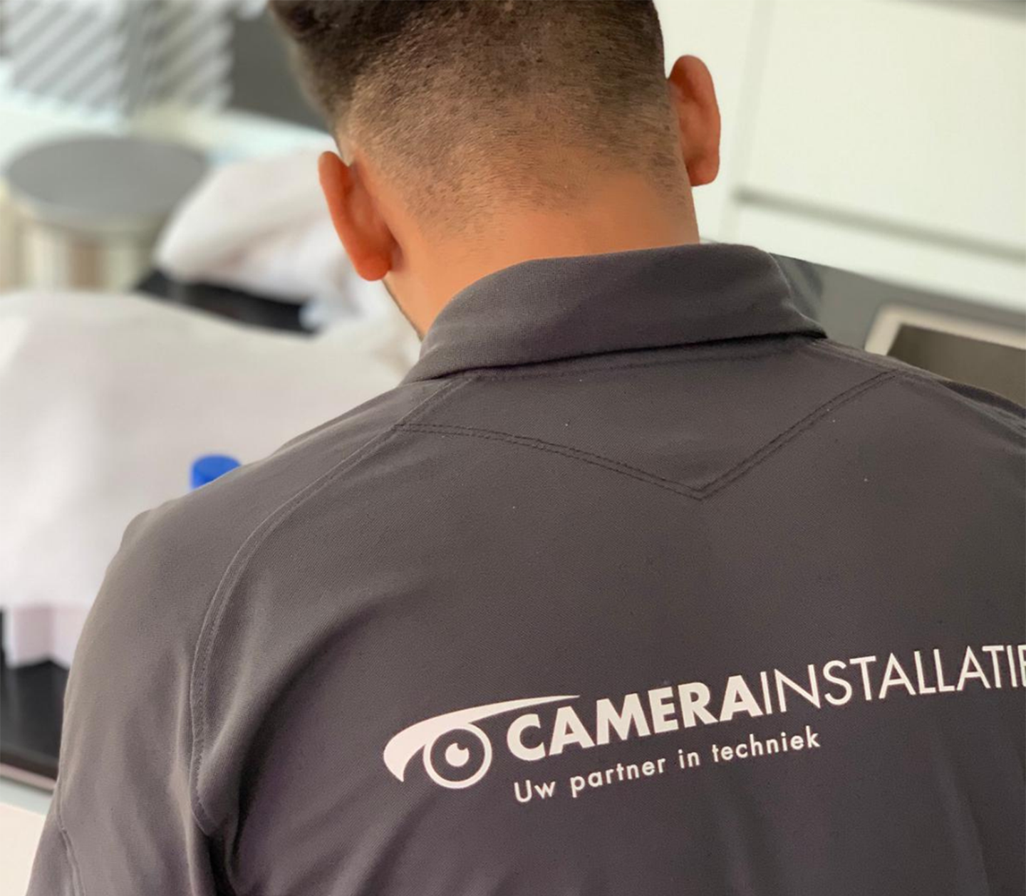 Monteur van CameraInstallatie.nl is een beveiligingscamera aan het installeren