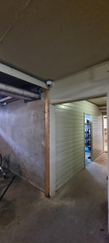 Domecamera aan het plafond van een bergingsgang in de kelder van een VvE in Rotterdam