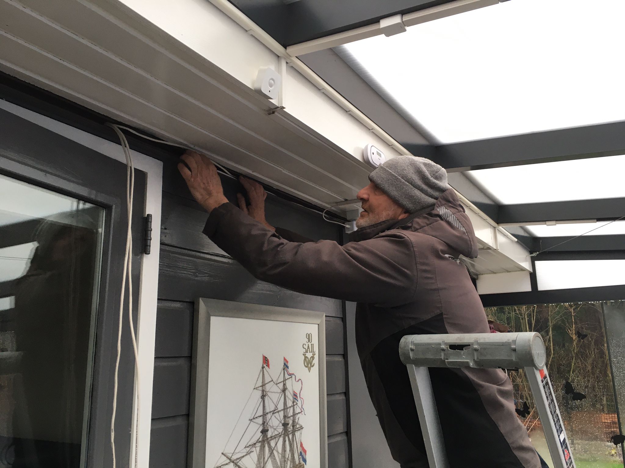 Engineer working under the veranda of a house
