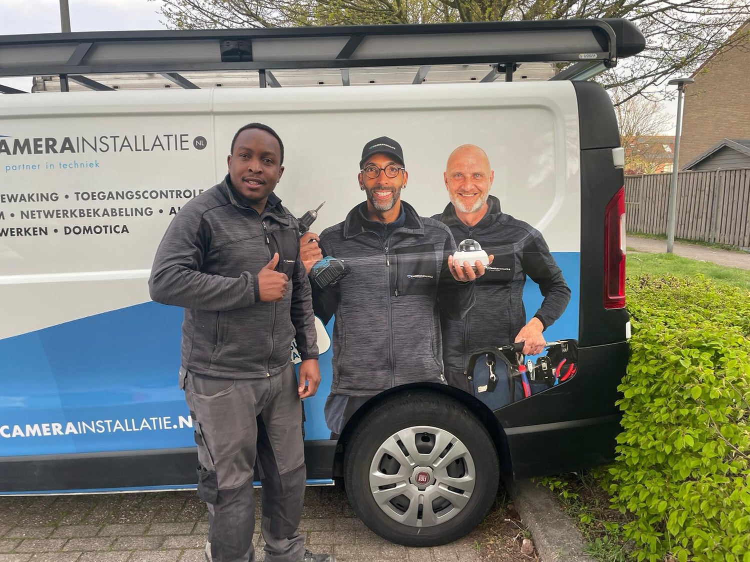 Drie monteurs van CameraInstallatie.nl bij hun eigen bedrijfsbus