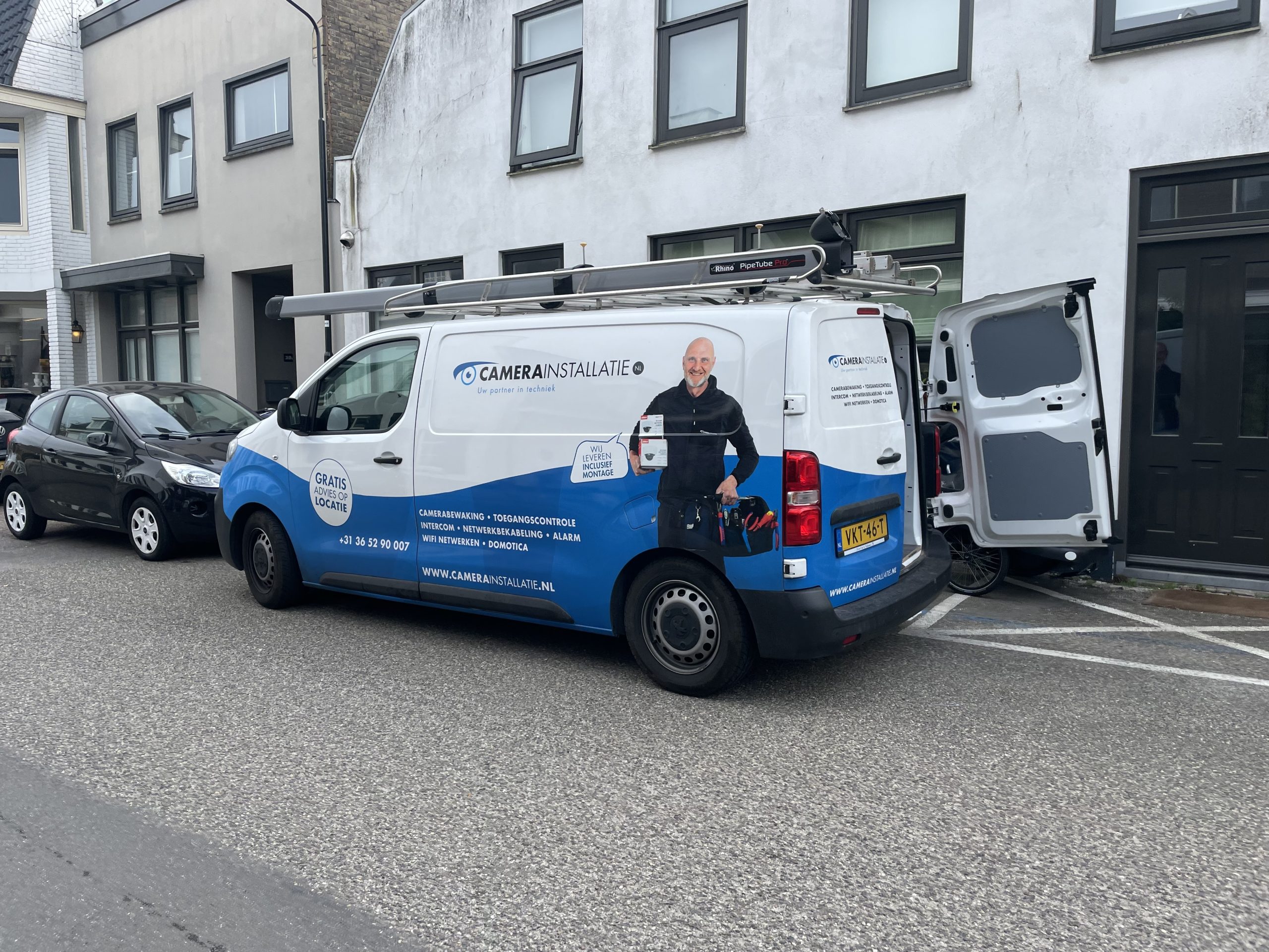 Bus van CameraInstallatie in een woonstraat tijdens het aanleggen van een alarmsysteem