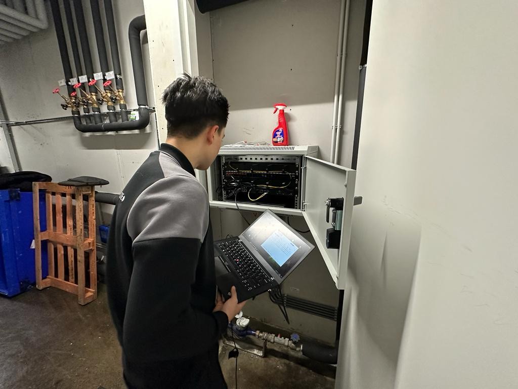 Monteur van CameraInstallatie leest de recorder uit in de technische ruimte van het complex