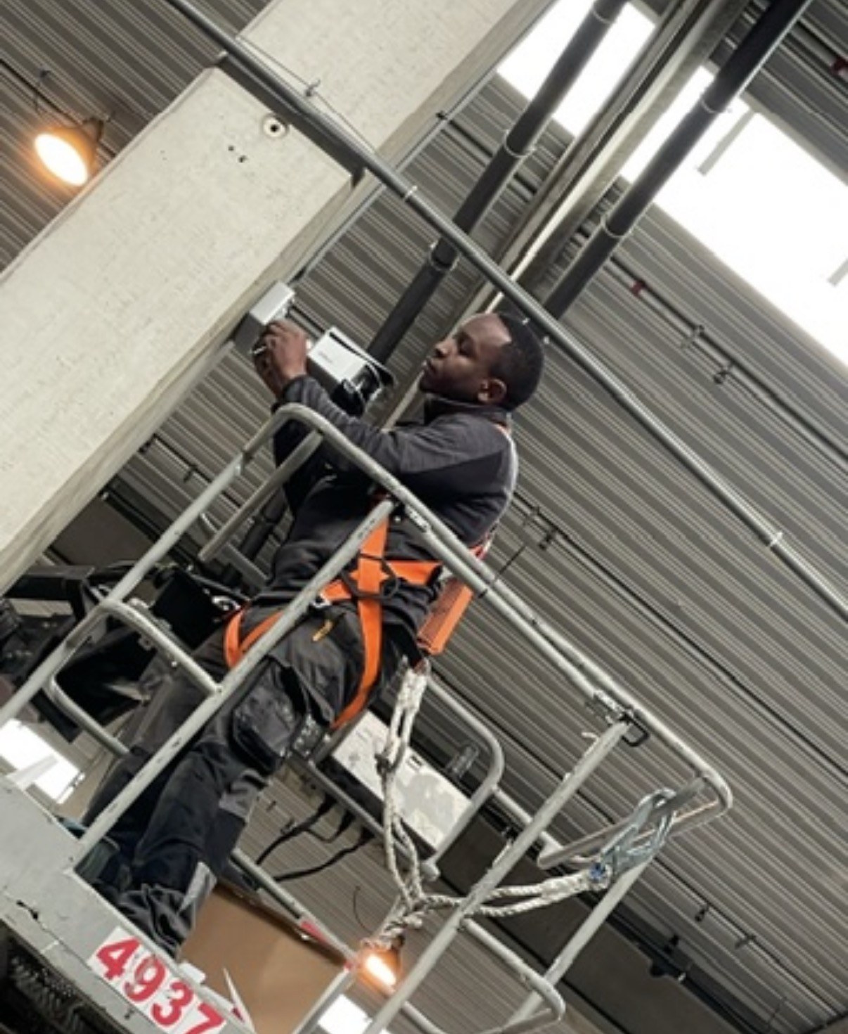 De camera wordt gemonteerd aan de betonnen ligger onder het dak